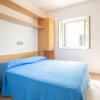 Camera da letto luminosa con letto matrimoniale blu.