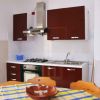 Cucina moderna con mobili marroni e tavolo da pranzo.